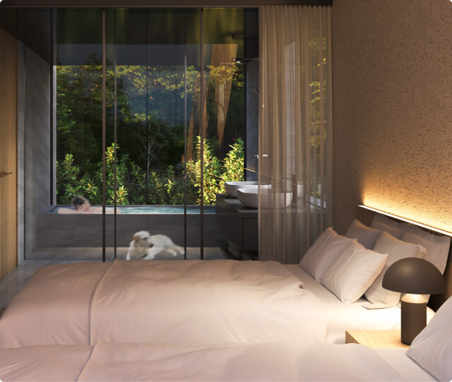 ベッドルームとガラス扉の奥には広々とした浴室がある